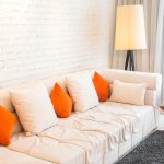Modern living room with plush sectional sofa, throw pillows, and soft lighting