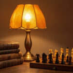 A warm amber table lamp glowing beside a stack of antique books and a chess set.