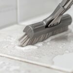 Bathroom tile grout being scrubbed professionally