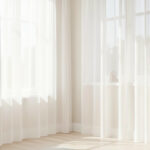 Bright room with sheer curtains and light-colored walls]
