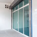 Close-up of bifold glass door hardware showing quality aluminium frame, slim sightlines and smooth folding mechanism