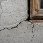 Diagonal wall crack near a window frame showing foundation movement.