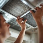 Image 1_ Homeowner checking HVAC filter replacement