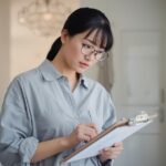 Person with clipboard checking items off a home maintenance list