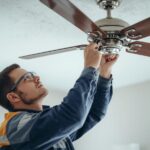Professional electrician installing ceiling fan
