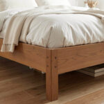 Bed risers adding clearance beneath a bed frame