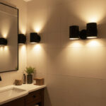 Black wall sconces providing warm ambient bathroom lighting