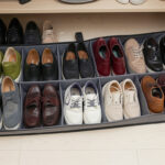 Flat under-bed shoe organizer with shoes neatly arranged