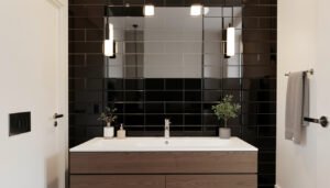 Glossy black tile accent wall behind a bathroom vanity