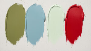 Several large paint sample swatches painted directly on a wall for side-by-side color comparison.